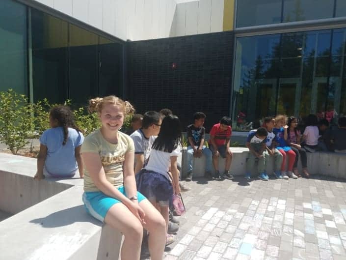 Kids in courtyard before the start of the Peace Pole Planting Ceremony out at Rockwood Boys & Girls Club