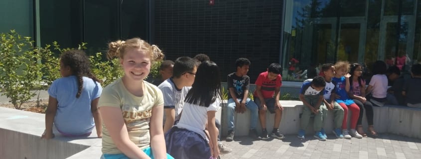 Kids in courtyard before the start of the Peace Pole Planting Ceremony out at Rockwood Boys & Girls Club